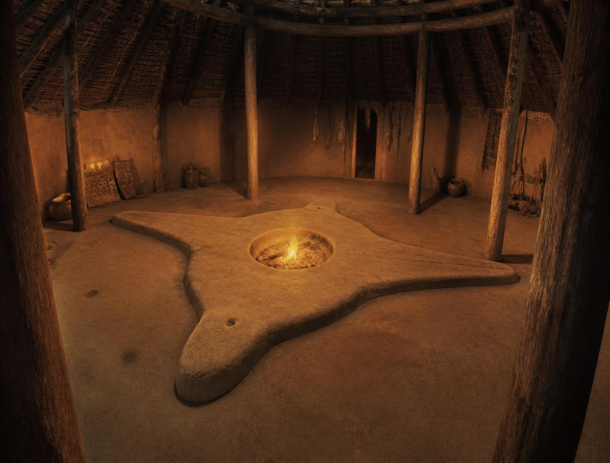 Interior of the reconstructed Earth Lodge with its bird-shaped clay floor